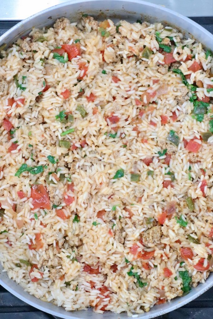 cooked rice in a skillet with ground meat and vegetables