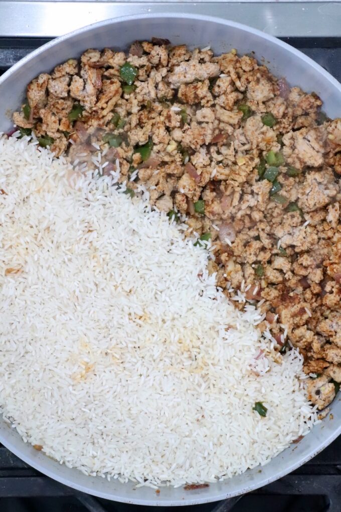 cooked, seasoned ground turkey in a skillet with white rice