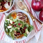 Grilled balsamic chicken & roasted butternut squash noodles are topped with a pomegranate apple arugula salad in this healthy, gluten free bowl recipe!
