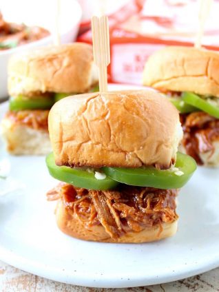 Hawaiian Chicken Sliders are easily made by tossing chicken, pineapple & Hawaiian BBQ sauce in a slow cooker for a few hours, then serving on Hawaiian rolls!