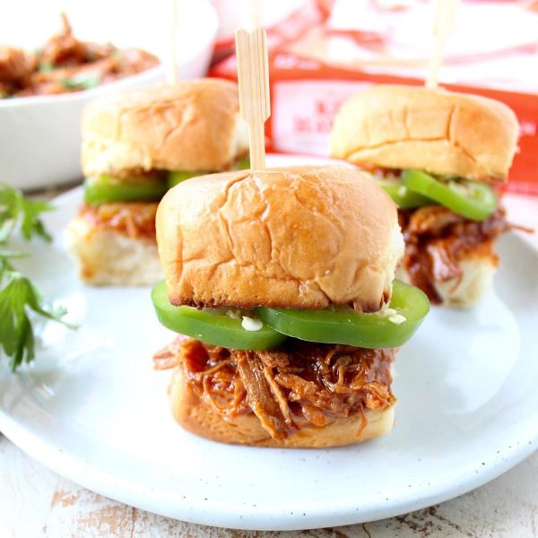 Hawaiian Chicken Sliders are easily made by tossing chicken, pineapple & Hawaiian BBQ sauce in a slow cooker for a few hours, then serving on Hawaiian rolls!