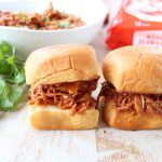 Hawaiian Chicken Sliders are easily made by tossing chicken, pineapple & Hawaiian BBQ sauce in a slow cooker for a few hours, then serving on Hawaiian rolls!