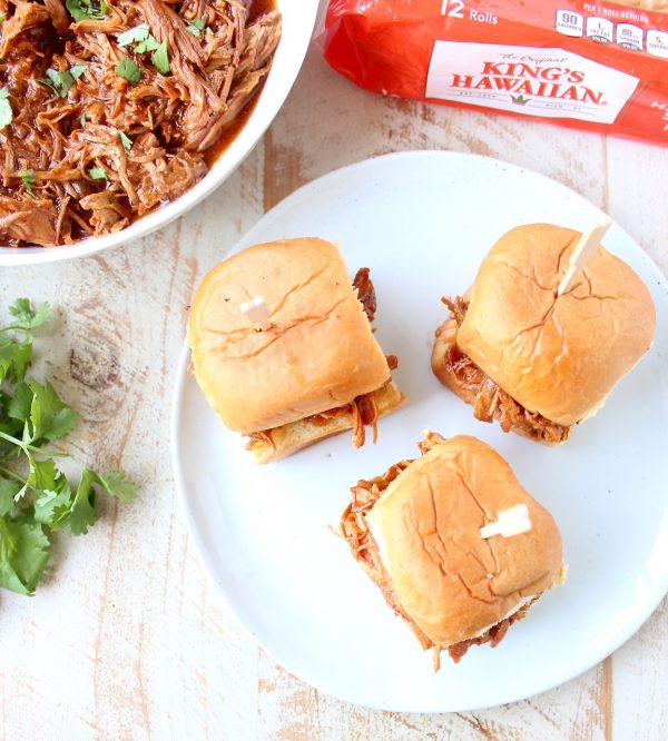 Hawaiian Chicken Sliders are easily made by tossing chicken, pineapple & Hawaiian BBQ sauce in a slow cooker for a few hours, then serving on Hawaiian rolls!