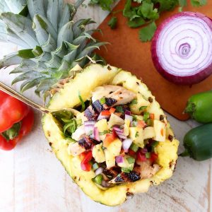 Grilled chicken teriyaki is served over zucchini noodles and topped with pineapple salsa in these healthy, gluten free and delicious zoodle bowls!