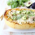 Green chili chicken is stuffed in roasted spaghetti squash and topped with gooey, melted pepper jack cheese for a delicious gluten free fall meal!