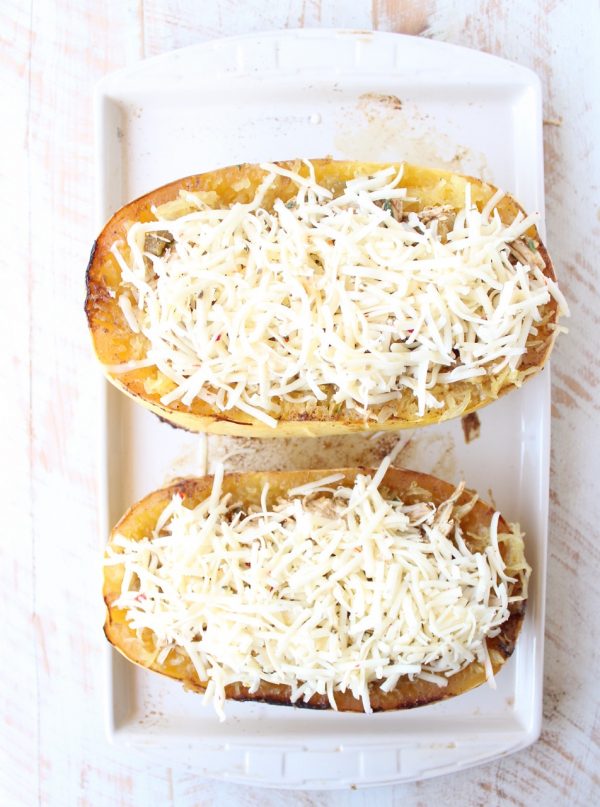 roasted spaghetti squash cut in half topped with shredded cheese