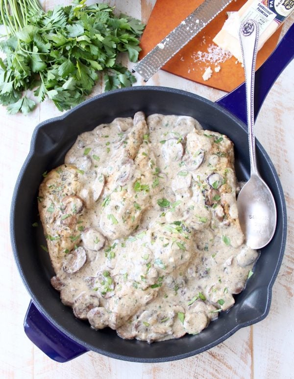 A decadently creamy mushroom sauce covers chicken parmesan in this quick and easy Mushroom Chicken recipe that you'll want to make over and over!