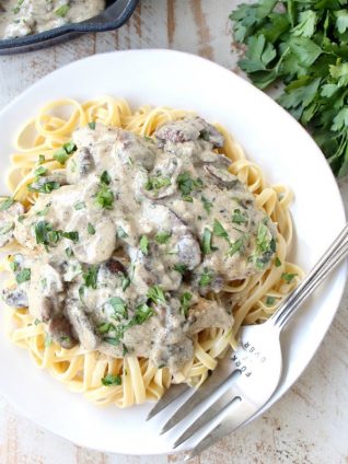 A decadently creamy mushroom sauce covers chicken parmesan in this quick and easy Mushroom Chicken recipe that you'll want to make over and over!