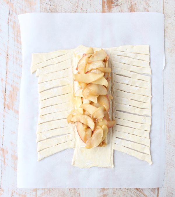 Warm caramelized apples & creamy brie cheese are wrapped up in a puff pastry for an easy & delicious apple strudel recipe, great for breakfast, an appetizer or dessert!