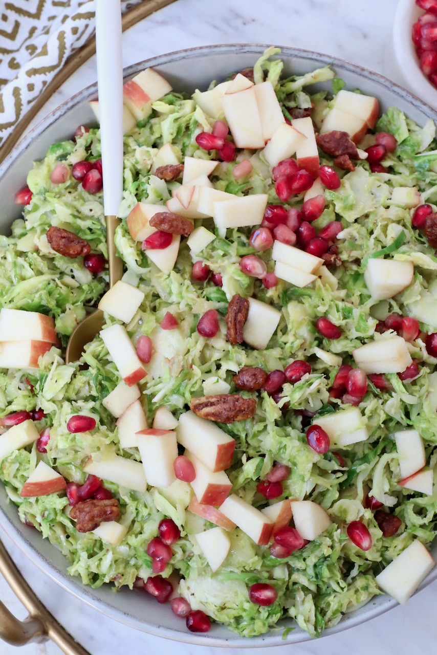 brussel sprout salad in a bowl with a spoon