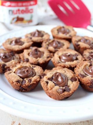 A simple chocolate chip cookie recipe is transformed into delicious chocolate chip cookie cups filled with Nutella Hazelnut Spread!