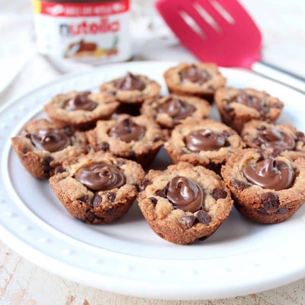 A simple chocolate chip cookie recipe is transformed into delicious chocolate chip cookie cups filled with Nutella Hazelnut Spread!