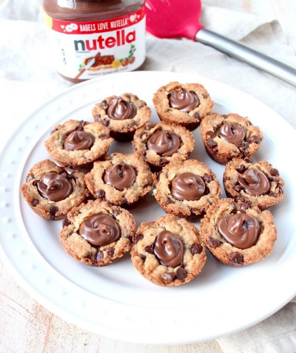 A simple chocolate chip cookie recipe is transformed into delicious chocolate chip cookie cups filled with Nutella Hazelnut Spread!