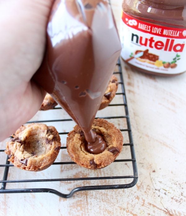 A simple chocolate chip cookie recipe is transformed into delicious chocolate chip cookie cups filled with Nutella Hazelnut Spread!