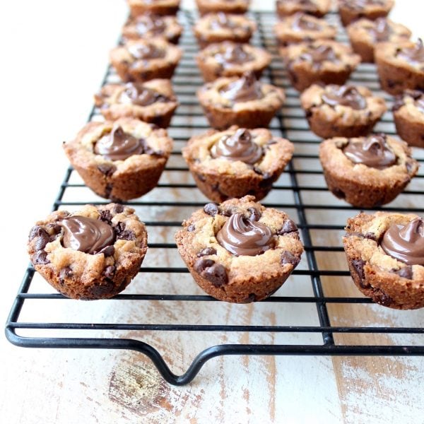 A simple chocolate chip cookie recipe is transformed into delicious chocolate chip cookie cups filled with Nutella Hazelnut Spread!
