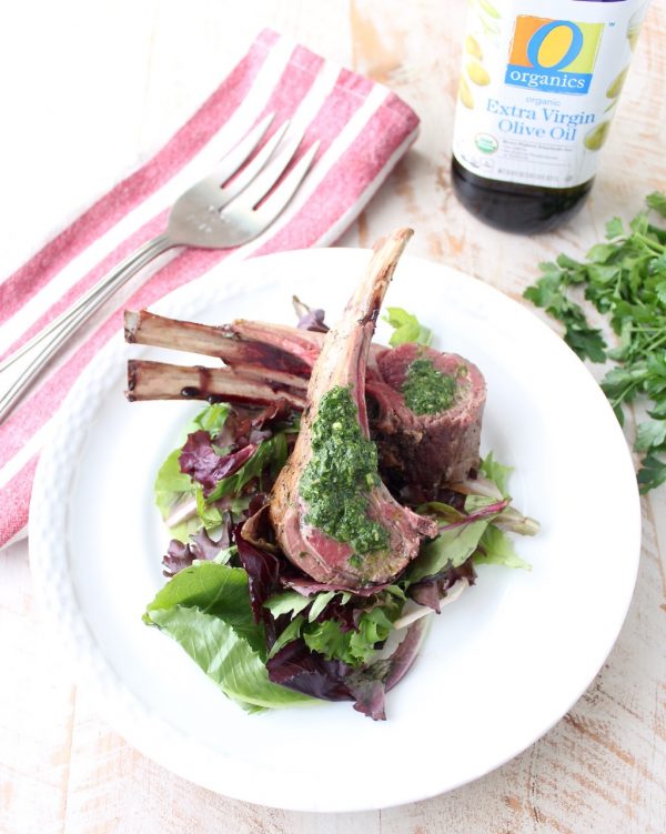 Rack of lamb is rubbed with herb butter, then roasted and topped with a mint chimichurri sauce in this elegant dinner recipe!