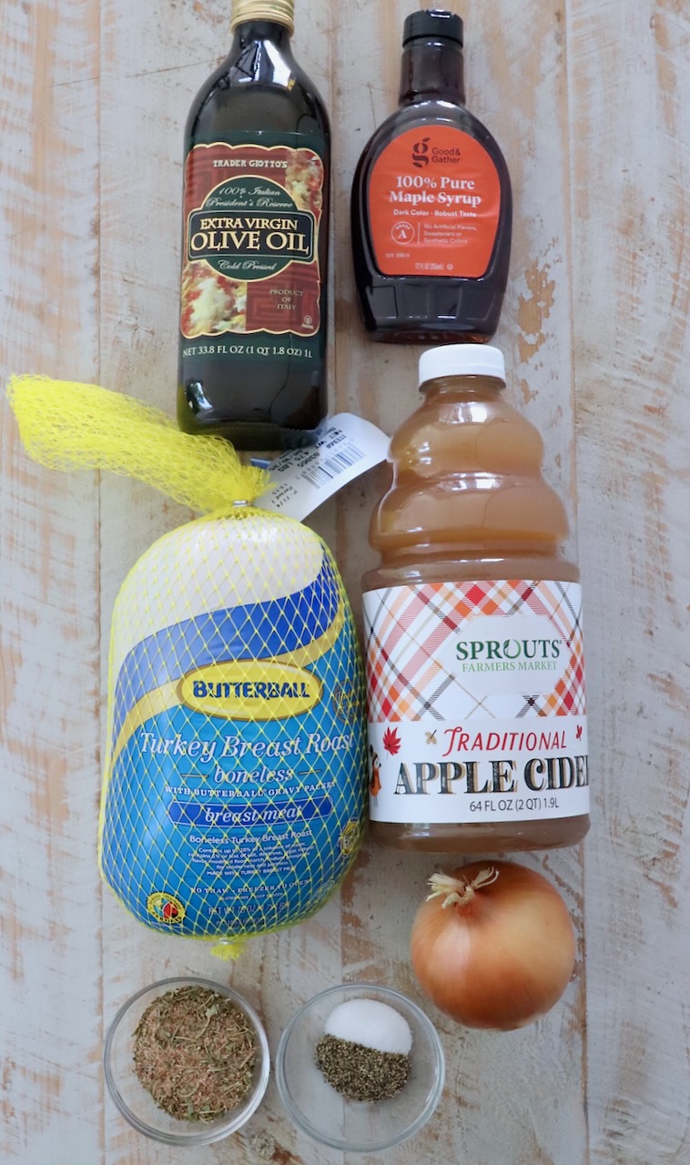 ingredients for maple apple turkey breast on a white wood board