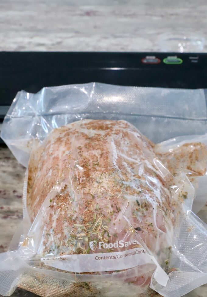 vacuum sealed turkey breast with seasonings in a bag