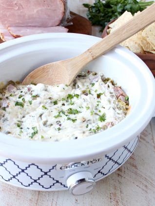 The ultimate game day party dip, this Ham and Cheese Jalapeno Popper Dip is so easy to make in the slow cooker and will be a hit with all of your friends!