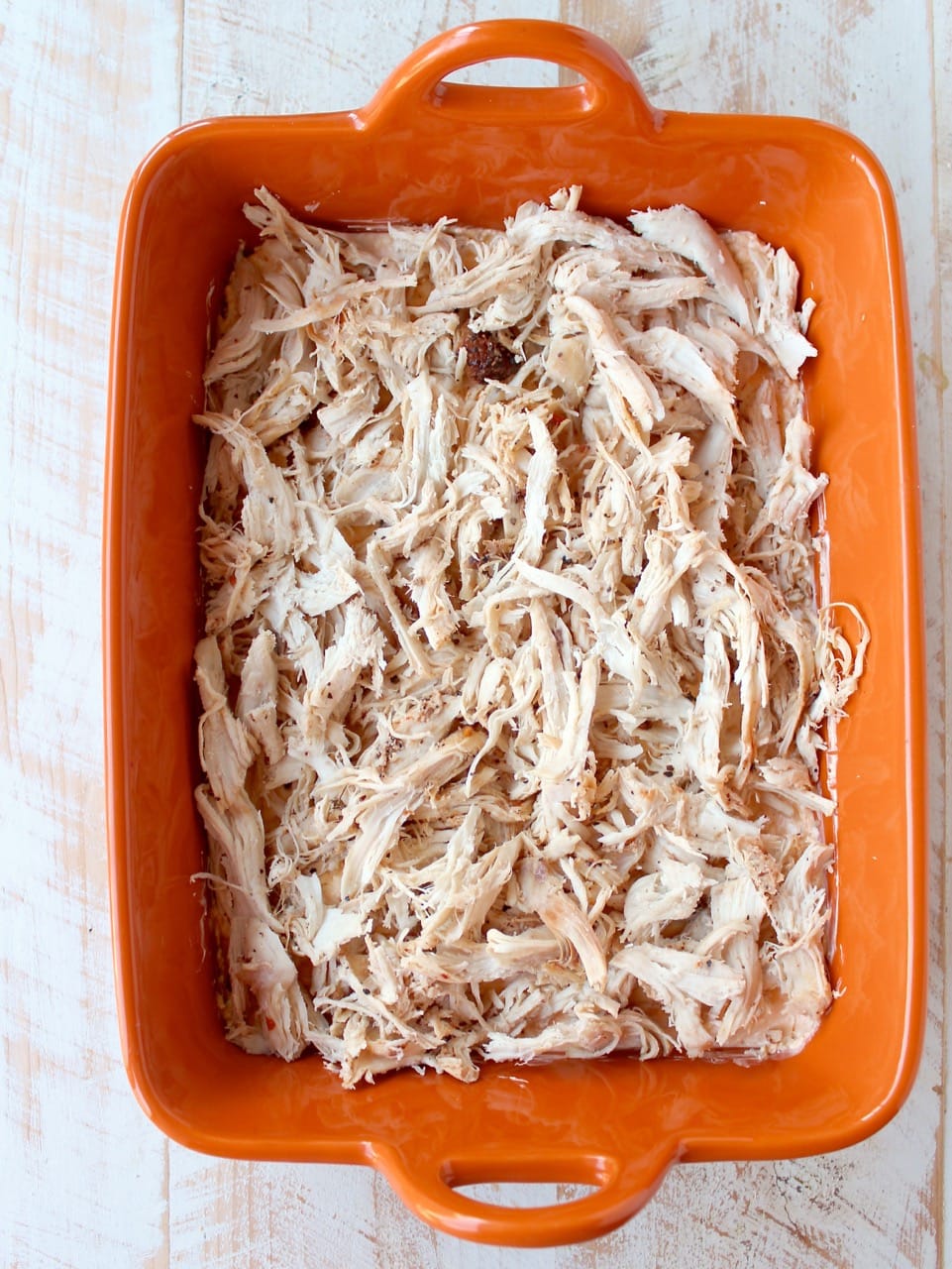 Shredded cajun turkey is placed on a layer of cajun ranch cream cheese and topped with cheddar cheese in this ultimate Cajun Turkey Cheese Dip recipe!