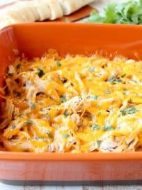 Shredded cajun turkey is placed on a layer of cajun ranch cream cheese and topped with cheddar cheese in this ultimate Cajun Turkey Cheese Dip recipe!
