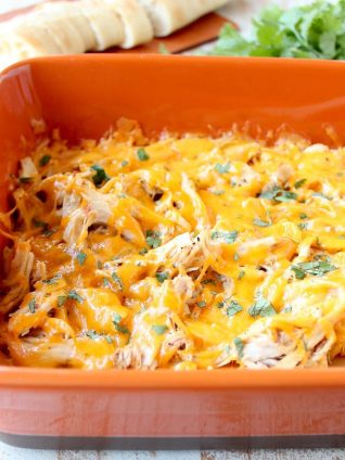 Shredded cajun turkey is placed on a layer of cajun ranch cream cheese and topped with cheddar cheese in this ultimate Cajun Turkey Cheese Dip recipe!