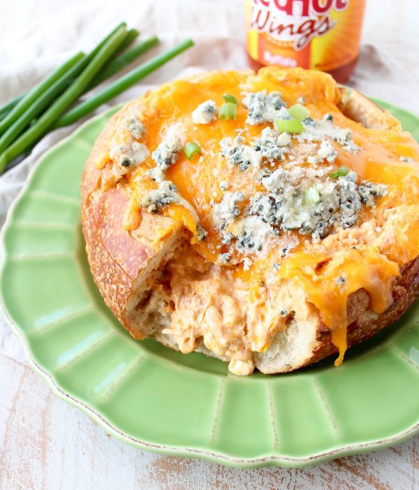 Everyone's favorite buffalo chicken dip is baked right into a bread bowl for the perfect party, game day or weekend appetizer!