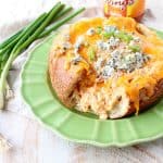 Everyone's favorite buffalo chicken dip is baked right into a bread bowl for the perfect party, game day or weekend appetizer!