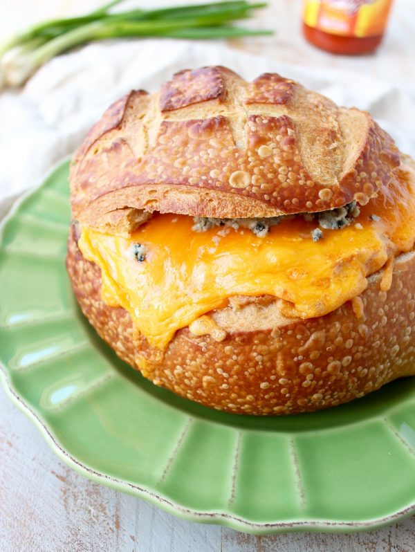 Everyone's favorite buffalo chicken dip is baked right into a bread bowl for the perfect party, game day or weekend appetizer!