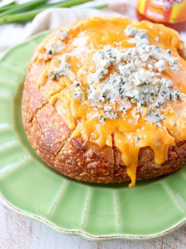 Everyone's favorite buffalo chicken dip is baked right into a bread bowl for the perfect party, game day or weekend appetizer!