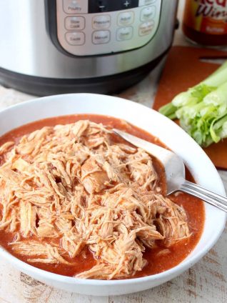 Easily make shredded buffalo chicken for tacos, dips or pasta recipes with this simple Instant Pot Buffalo Chicken recipe!