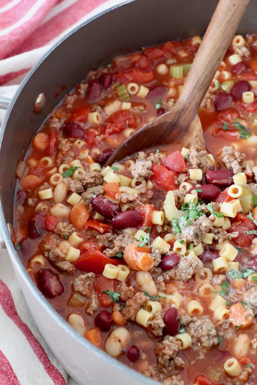 pasta fagioli soup in pot with serving spoon