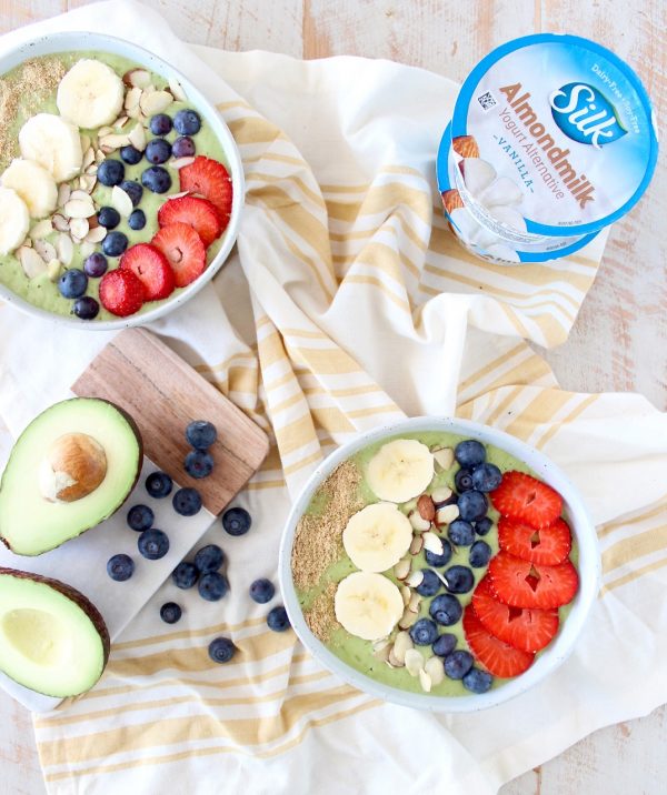 Fresh avocados, bananas and spinach are blended up with almond milk yogurt and coconut water in this delicious, vegan avocado smoothie bowl recipe!