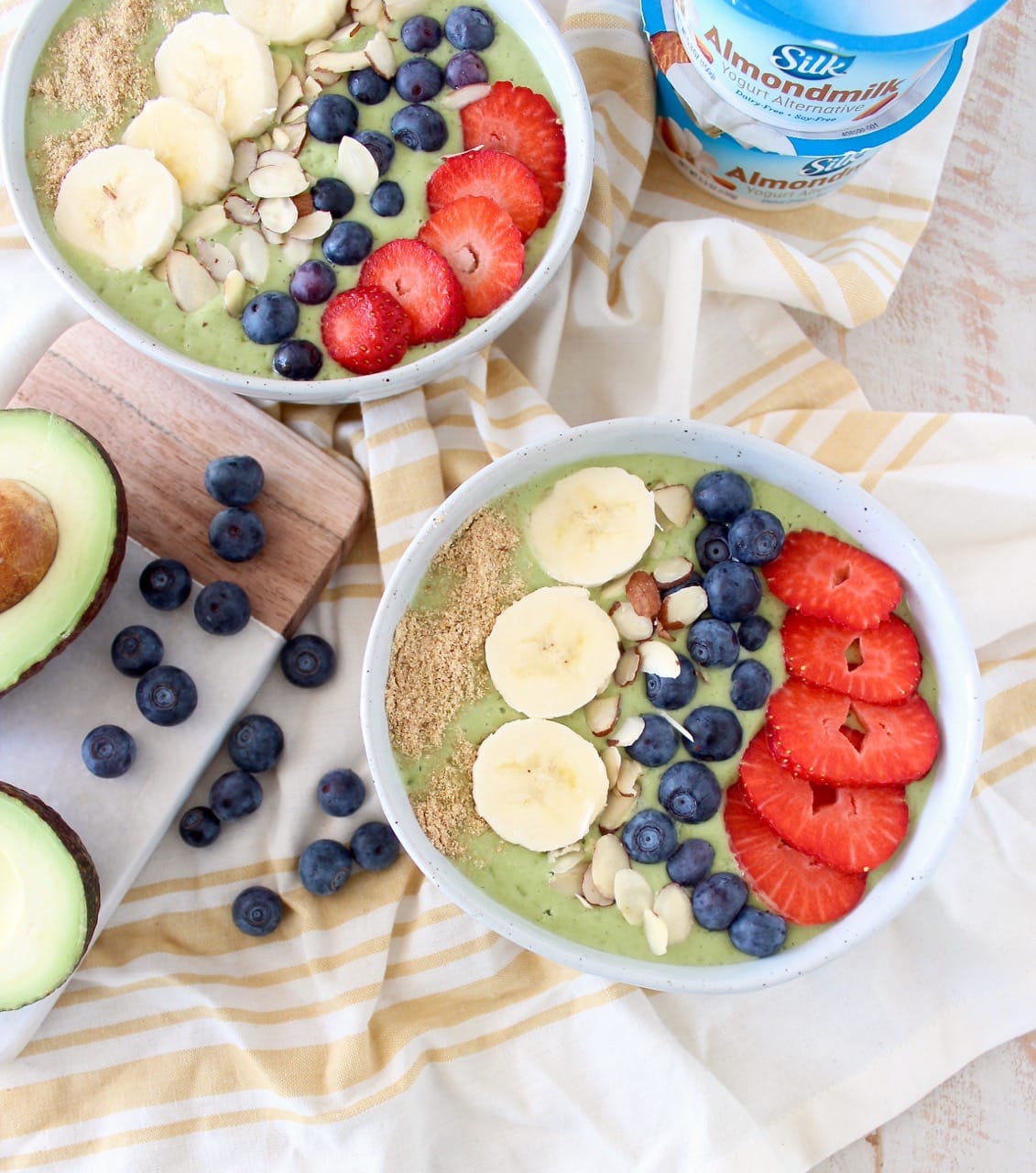 Fresh avocados, bananas and spinach are blended up with almond milk yogurt and coconut water in this delicious, vegan avocado smoothie bowl recipe!