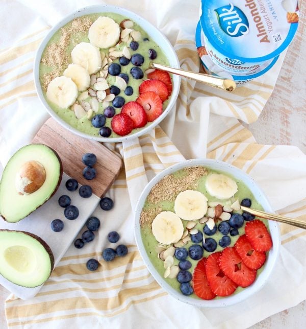 Fresh avocados, bananas and spinach are blended up with almond milk yogurt and coconut water in this delicious, vegan avocado smoothie bowl recipe!