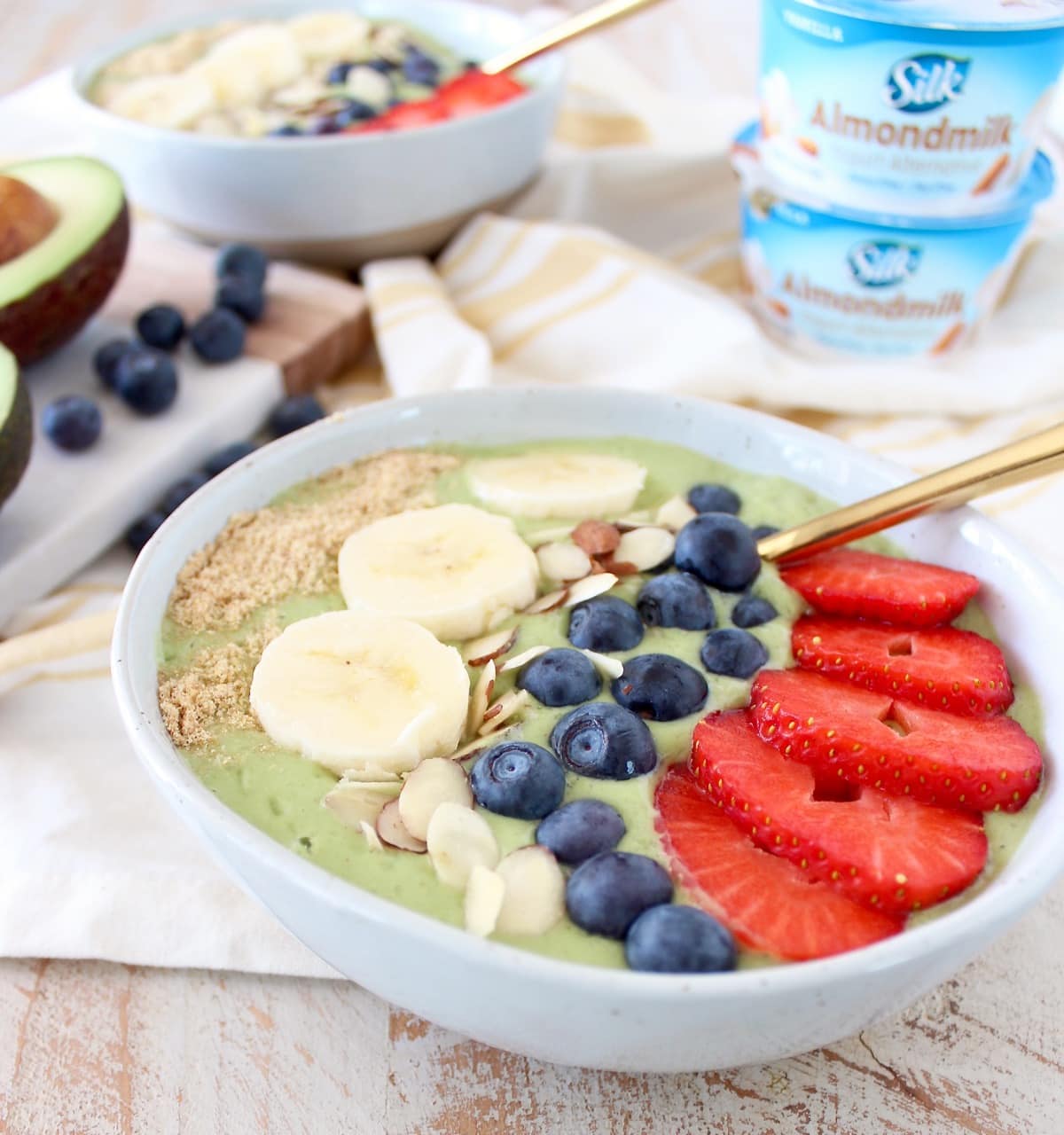 Fresh avocados, bananas and spinach are blended up with almond milk yogurt and coconut water in this delicious, vegan avocado smoothie bowl recipe!