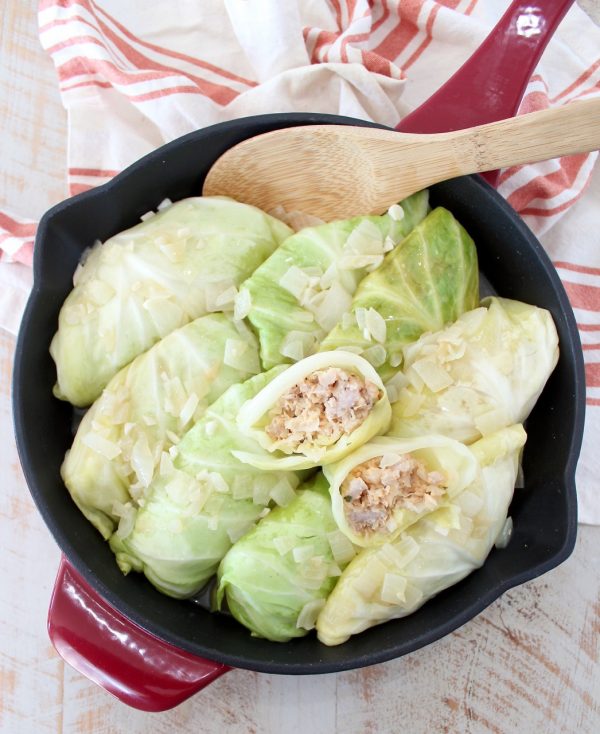 These German inspired Cabbage Rolls are filled with ground pork and sauerkraut, then simmered in a garlic onion broth for an amazingly flavorful recipe! 