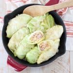 These German inspired Cabbage Rolls are filled with ground pork and sauerkraut, then simmered in a garlic onion broth for an amazingly flavorful recipe!