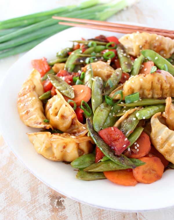 In this scrumptious Chicken Potsticker Stir Fry recipe, fresh veggies, chicken potstickers and a simple stir fry sauce are tossed together in one pan in under 30 minutes for an easy weeknight meal!