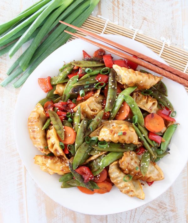 In this scrumptious Chicken Potsticker Stir Fry recipe, fresh veggies, chicken potstickers and a simple stir fry sauce are tossed together in one pan in under 30 minutes for an easy weeknight meal!