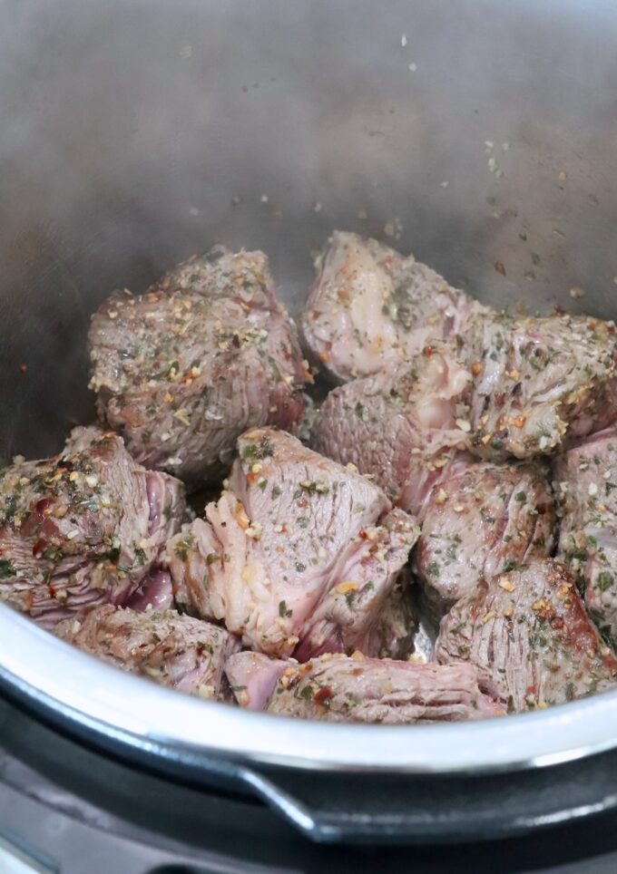 seared chunks of beef chuck roast in an Instant Pot