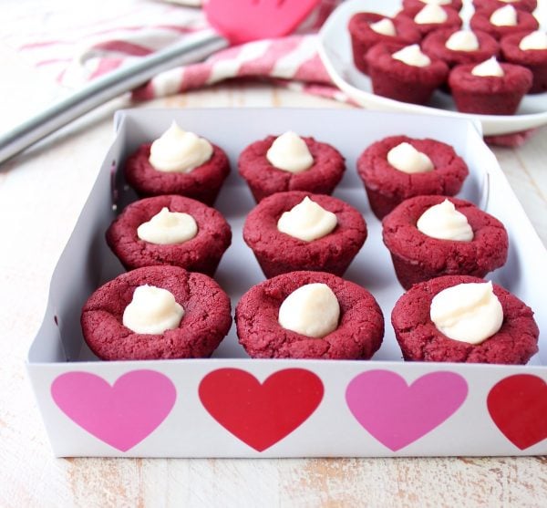 Red velvet cookie cups filled with cream cheese frosting are a delicious and adorable dessert recipe that's also easy to make! Perfect for Valentine's Day, birthdays or any day you're craving a sweet treat!