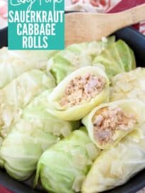 cabbage rolls in skillet with wooden spoon