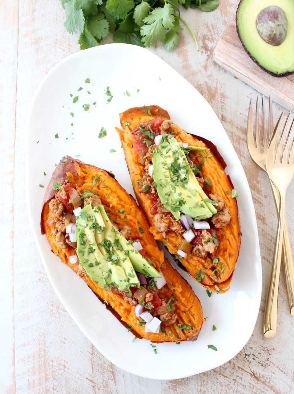 Deliciously easy Whole30 chipotle chili is added to these stuffed sweet potatoes for a scrumptious gluten free and dairy free meal, made in under an hour!