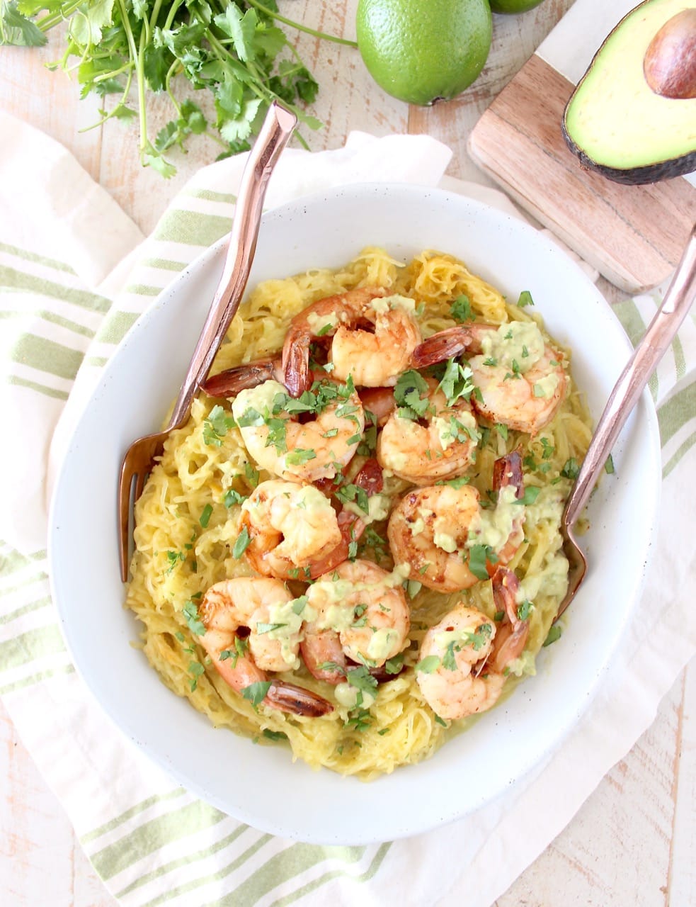 This delicious Whole30 recipe combines roasted spaghetti squash and green chili avocado sauce with cilantro lime shrimp for a healthy, gluten free and dairy free meal!