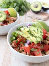 Taco seasoned ground turkey cooked with peppers, onions and tomatoes, tops this gluten free, dairy free, Whole30 taco salad recipe, made in just 20 minutes!