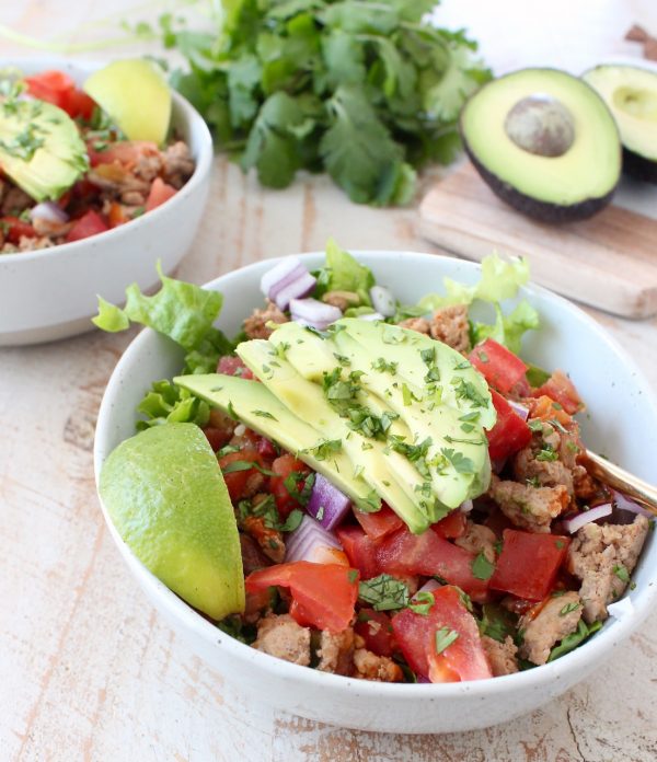 Taco seasoned ground turkey cooked with peppers, onions and tomatoes, tops this gluten free, dairy free, Whole30 taco salad recipe, made in just 20 minutes!