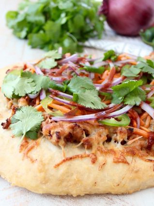 Turn your favorite banh mi sandwich into a pizza with this easy and delicious Banh Mi Pizza recipe, topped with sesame ginger ground pork, fresh carrots, jalapeños, cilantro and Sriracha!