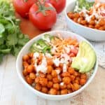Buffalo chickpeas, quinoa and veggies are tossed together in this healthy, gluten free, vegan buddha bowl recipe, topped with an easy homemade vegan ranch dressing, all made in just 20 minutes!