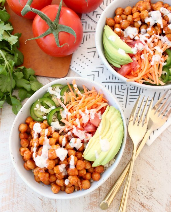 Buffalo chickpeas, quinoa and veggies are tossed together in this healthy, gluten free, vegan buddha bowl recipe, topped with an easy homemade vegan ranch dressing, all made in just 20 minutes!